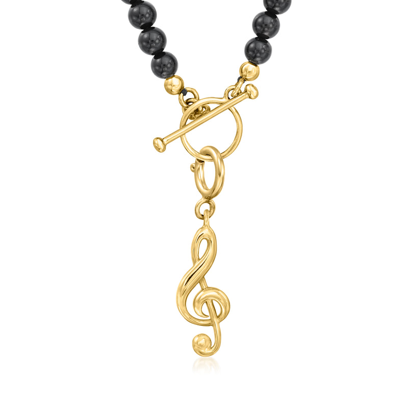 Gold treble clef charm with linked ring and clasp detail