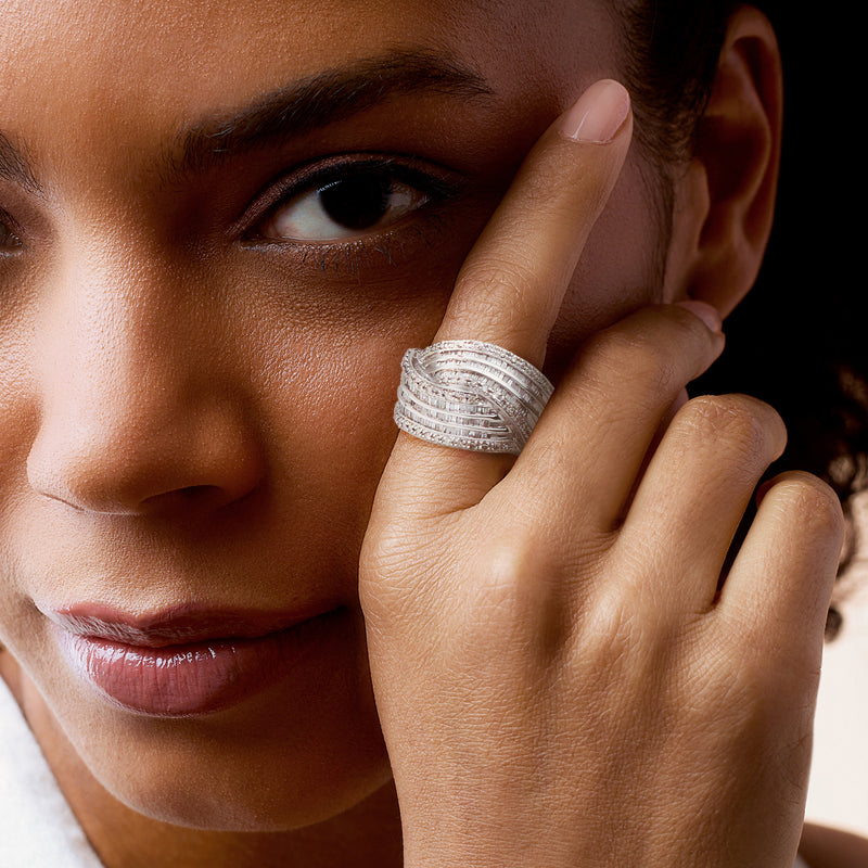 14kt white gold diamond crisscross ring with stacked bands on finger close-up