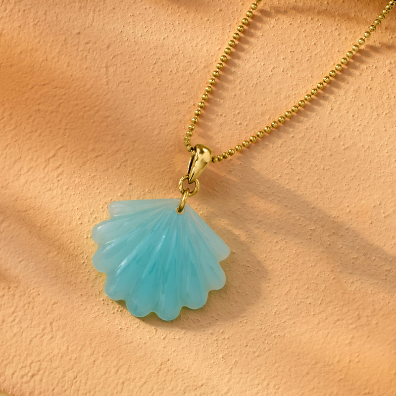 Gold-tone chain with small blue seashell pendant charm and loop clasp