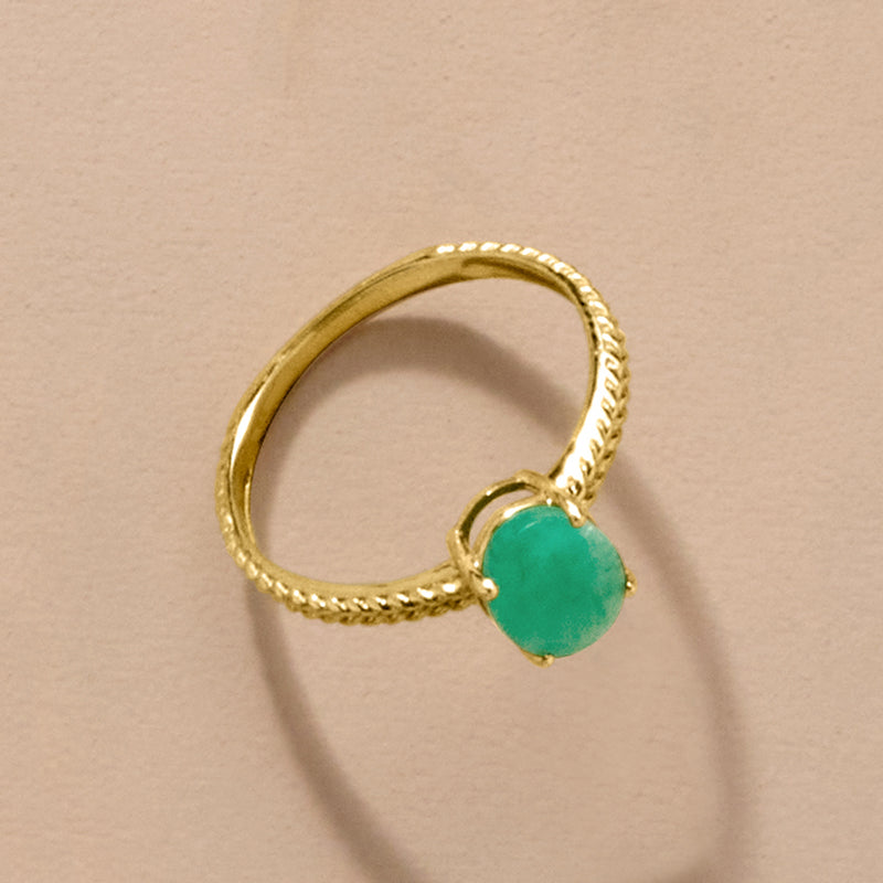 10kt yellow gold twisted rope ring with small prong-set green oval gemstone