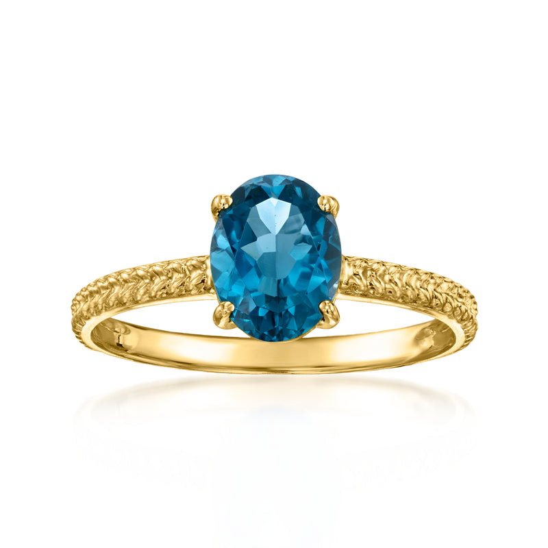 Twisted yellow gold ring with oval blue topaz in four-prong setting