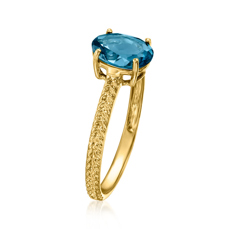 Side view of twisted yellow gold ring with oval blue topaz gemstone