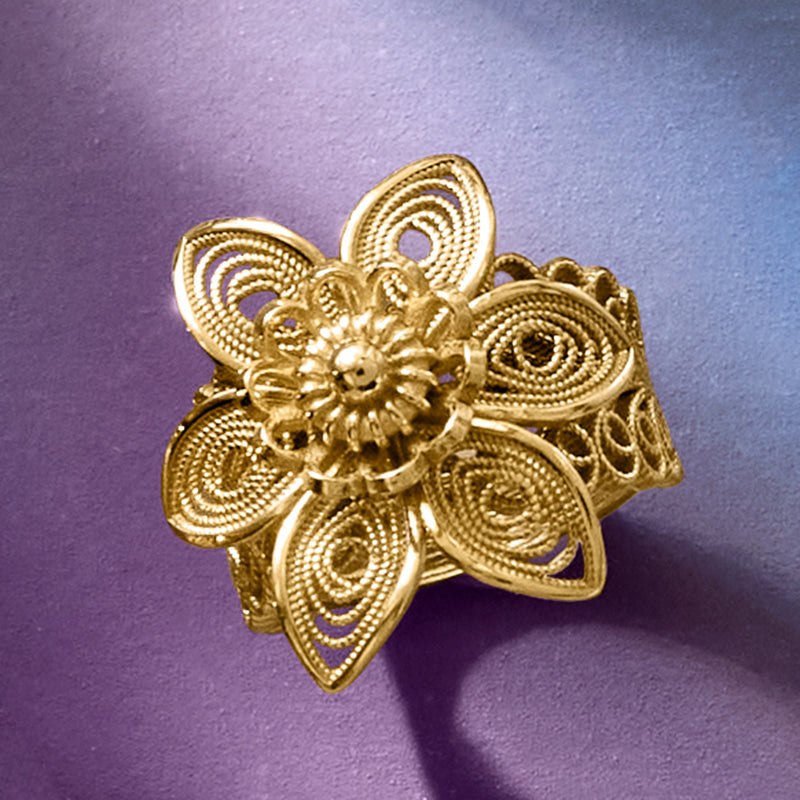 Gold filigree flower ring with embossed petal swirls and round center