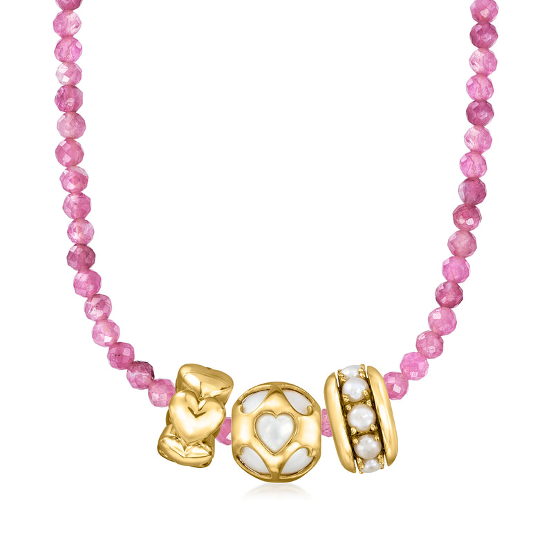 Pink beaded necklace featuring a gold heart charm with white pearl details