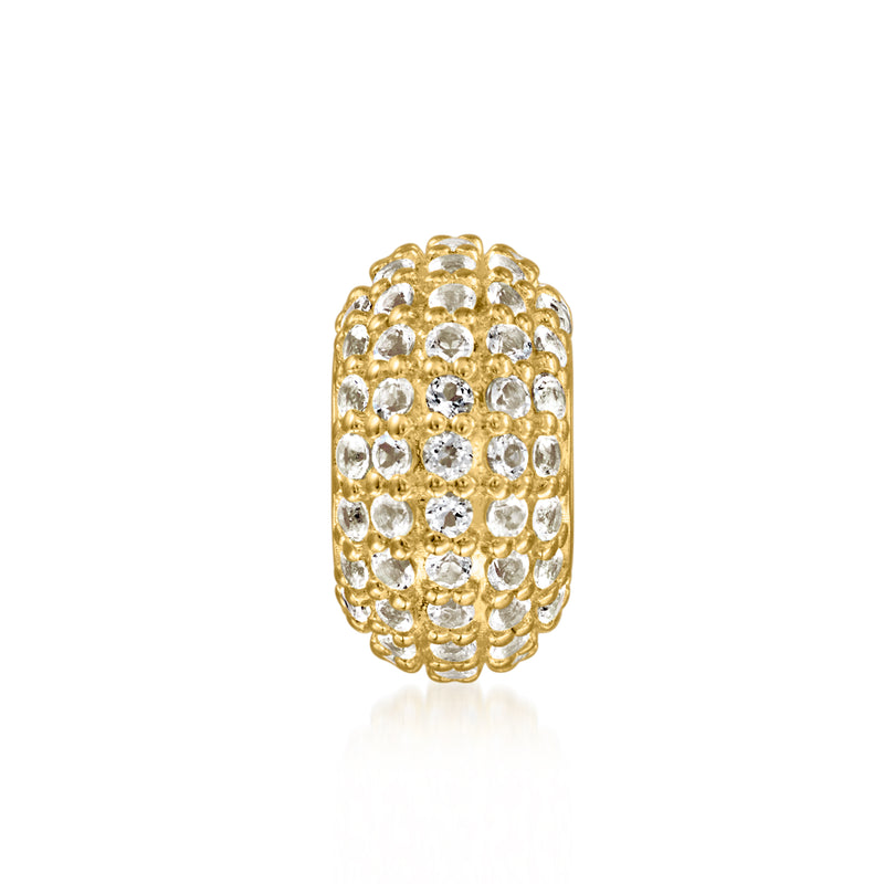 Gold bead charm with oval rows of white topaz stones in a sparkling bezel