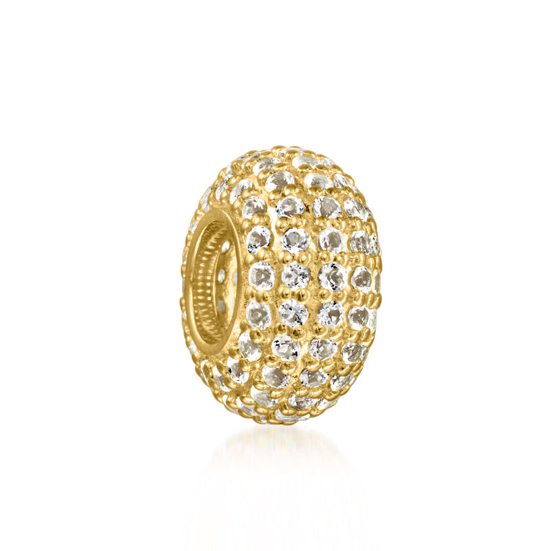 Oval gold bead charm with rows of white topaz stones and a visible open back