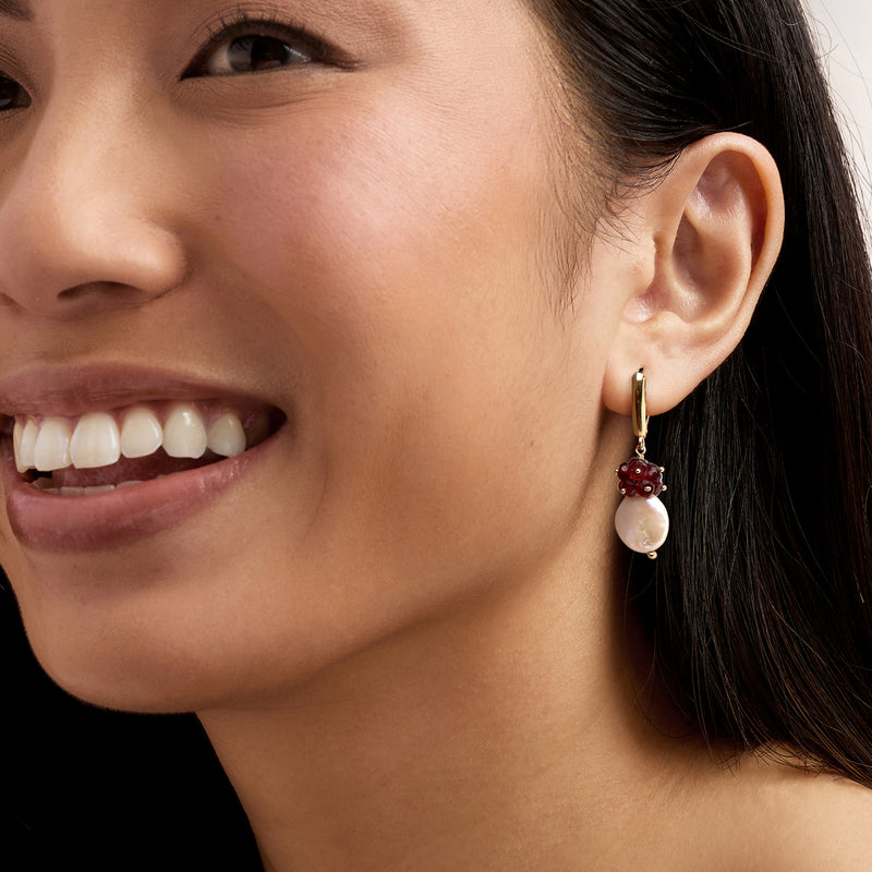 Leverback drop earrings in yellow gold with garnet cluster and coin pearl on model