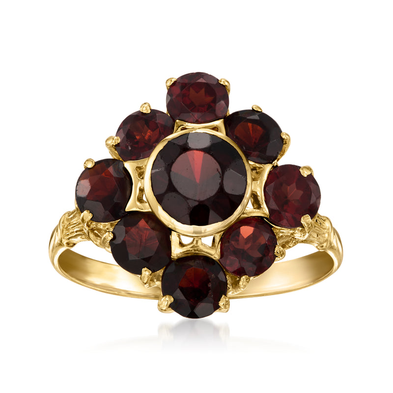 18kt yellow gold garnet cluster ring with oval red gemstones and round center