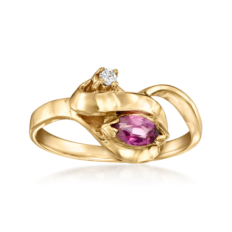 Vintage yellow gold ring with oval purple gemstone center and small diamond accents