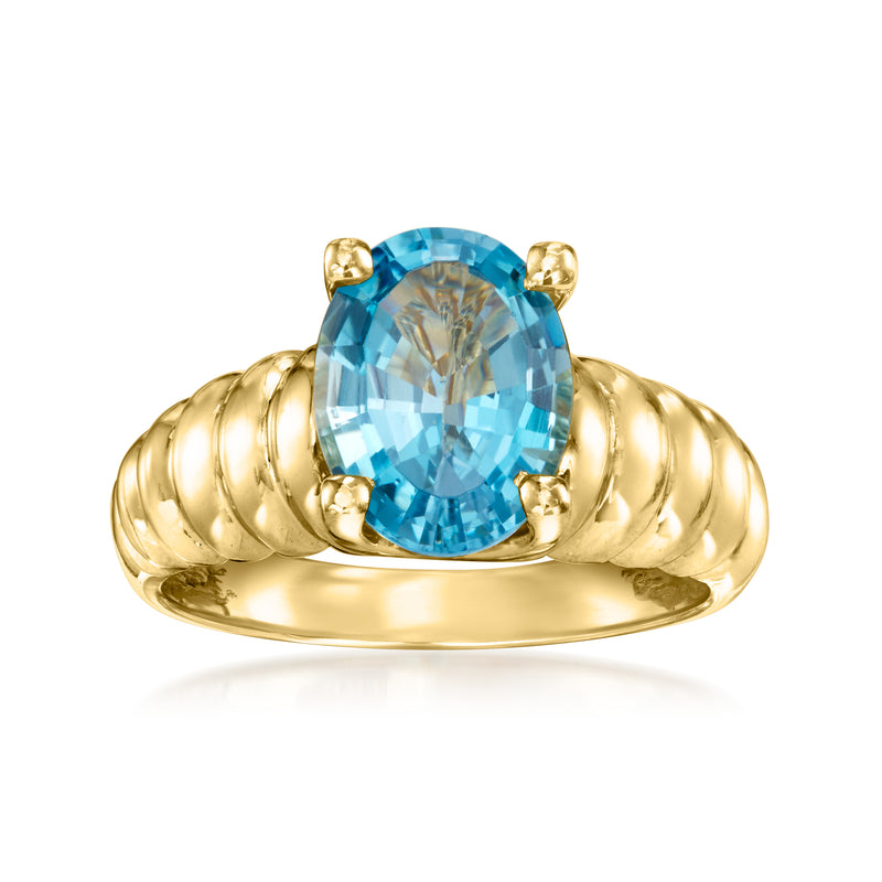 Vintage yellow gold ring with oval Swiss blue topaz center stone, four prongs