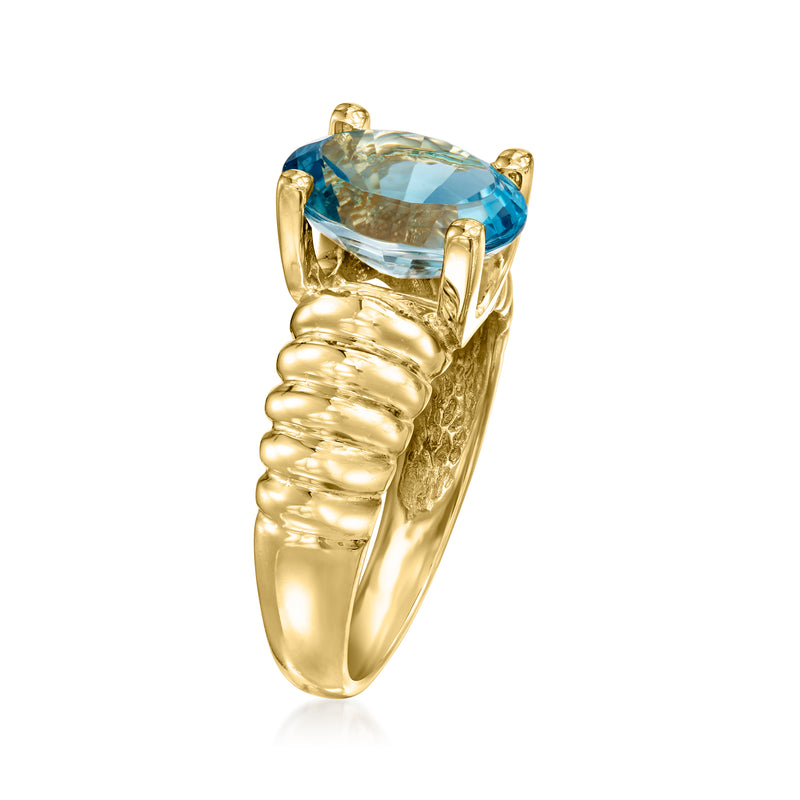 14kt yellow gold ring with oval blue topaz, rounded ribbed band, four prongs