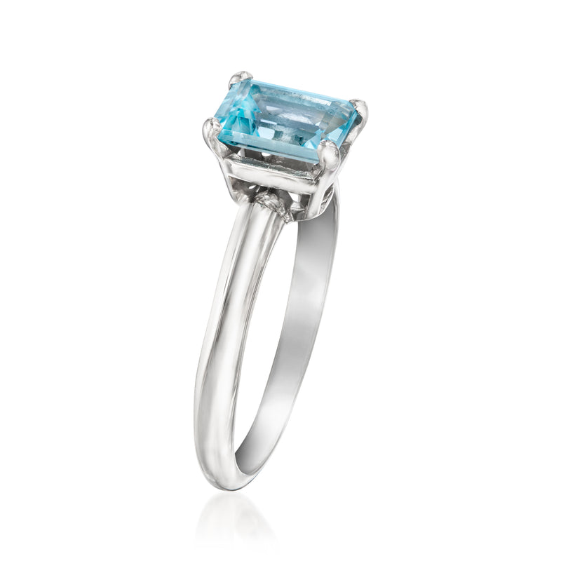 Platinum ring with emerald-cut sky-blue gemstone in a four-prong setting