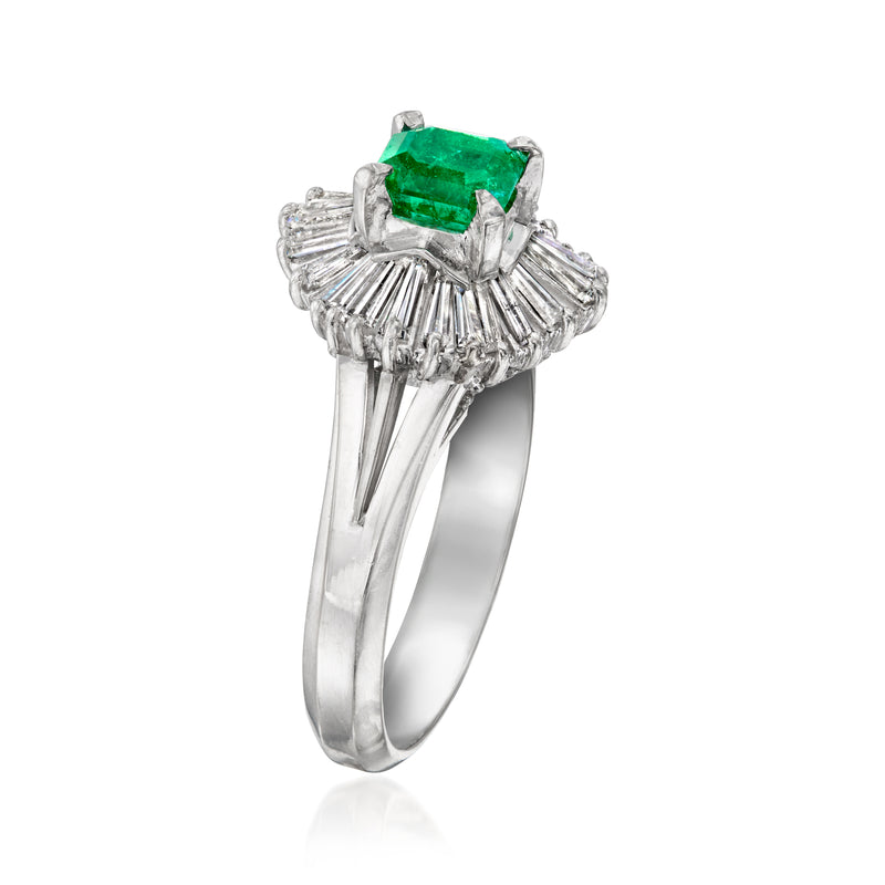 Platinum ring with emerald-green emerald-cut stone and baguette diamond halo