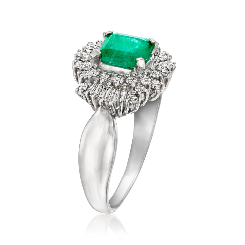 Vintage platinum emerald and diamond ring with rectangular green center stone.