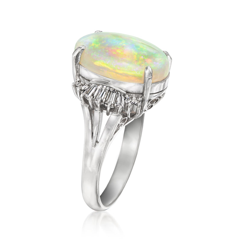 Platinum opal ring with oval opal in halo of baguette and round diamonds
