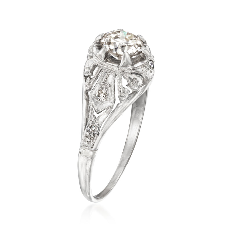 Platinum vintage diamond ring with round center stone and carved filigree side panel