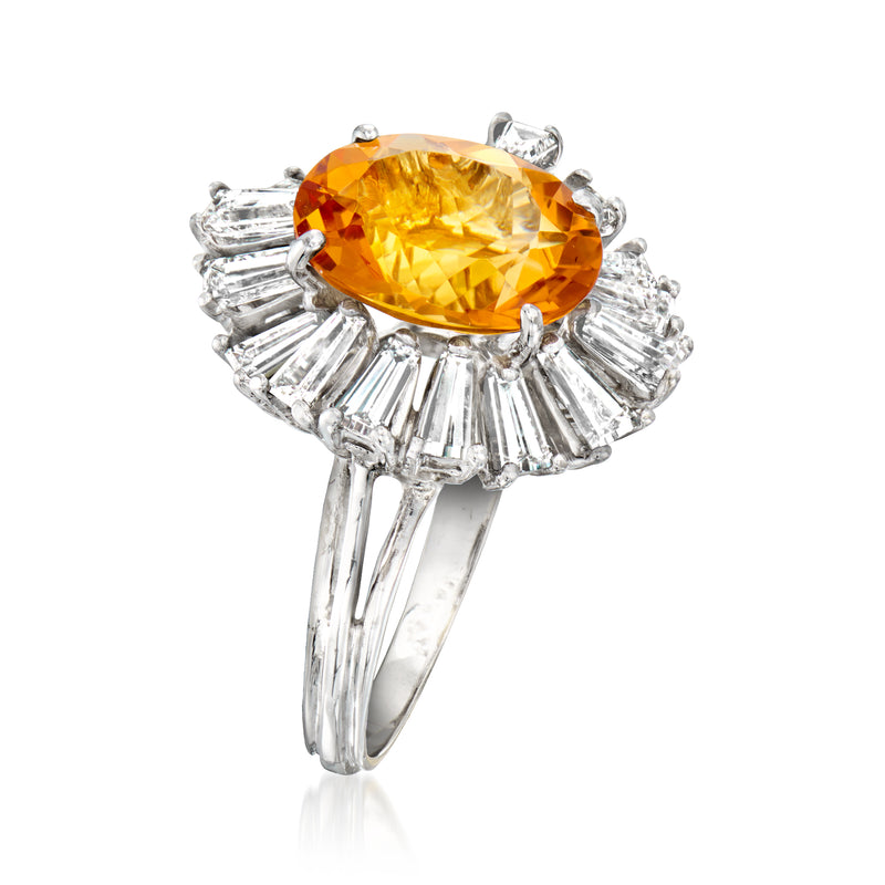 Side view of oval orange citrine ring with baguette diamond halo in white gold