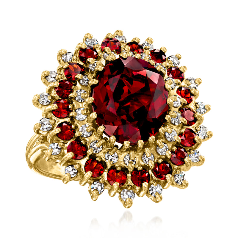 18kt yellow gold vintage ring featuring a red garnet center with sparkling diamond trim