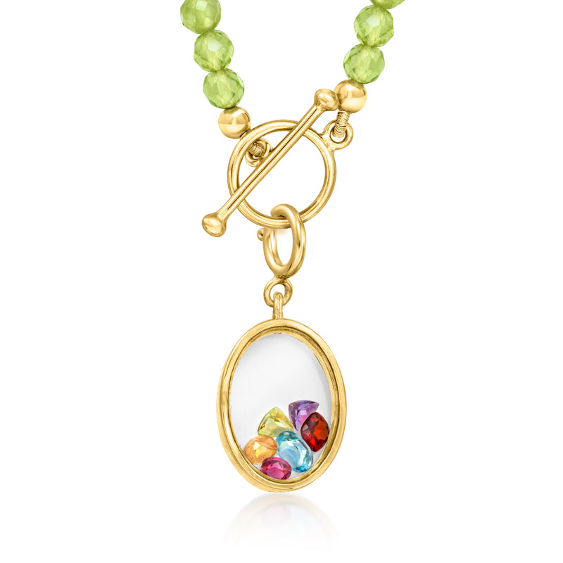 Gold oval charm with multicolor gemstone glass insert, shown on green bead strand