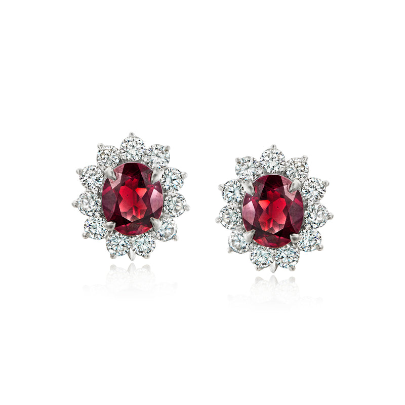 Platinum clip earrings with red oval garnet and diamond cluster halo, stud-style front