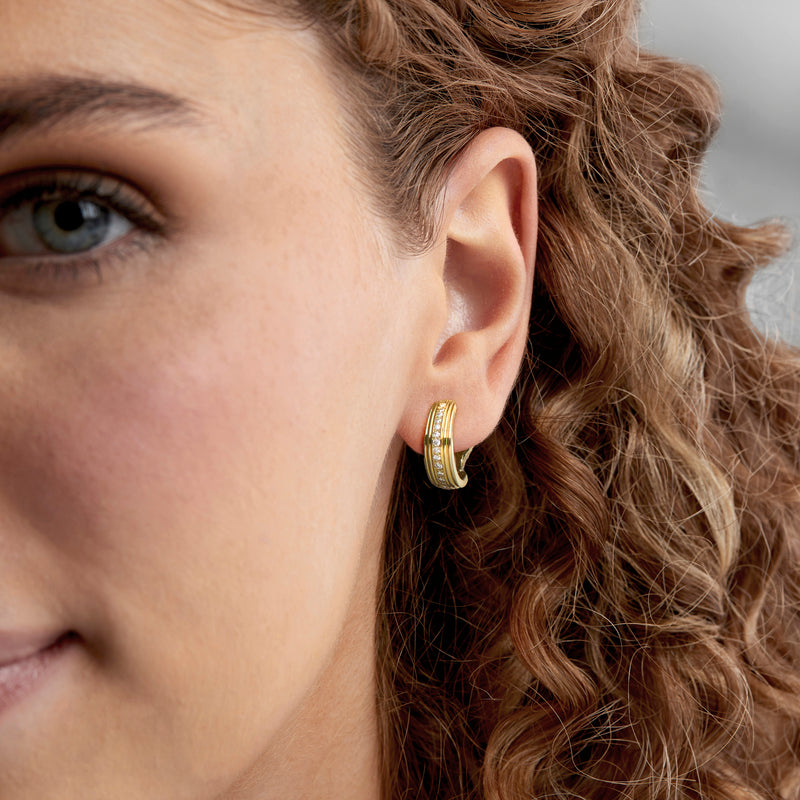Vintage curved diamond earrings in 18kt yellow gold on ear