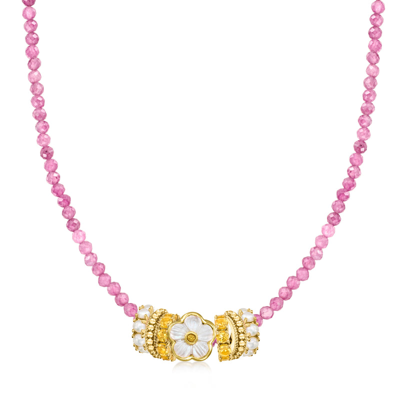 Pink beaded necklace featuring a gold-tone flower charm with white petals and yellow center