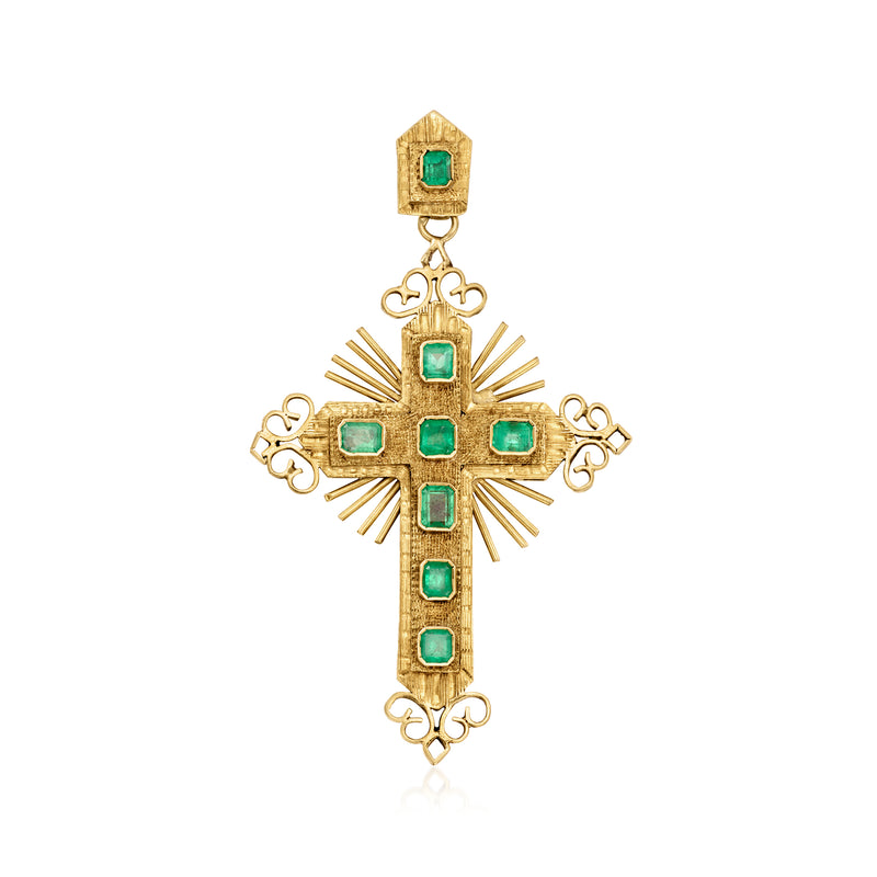 Gold cross pendant with green gemstones and ornate scrollwork bail