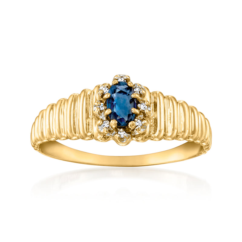 Yellow gold ring with oval blue sapphire center and diamond halo, ribbed band