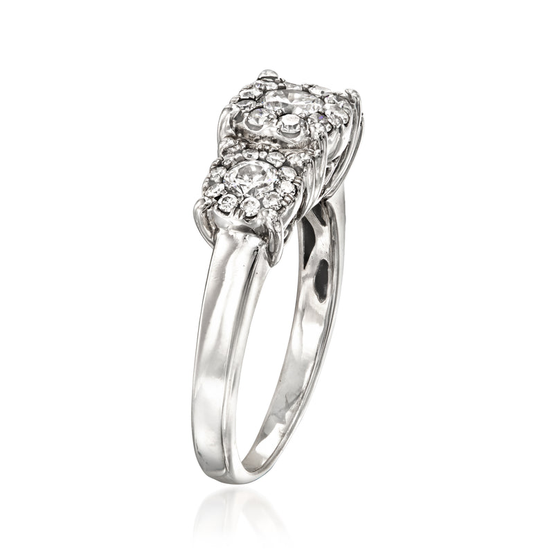White gold diamond cluster ring shown from the side with raised prong setting