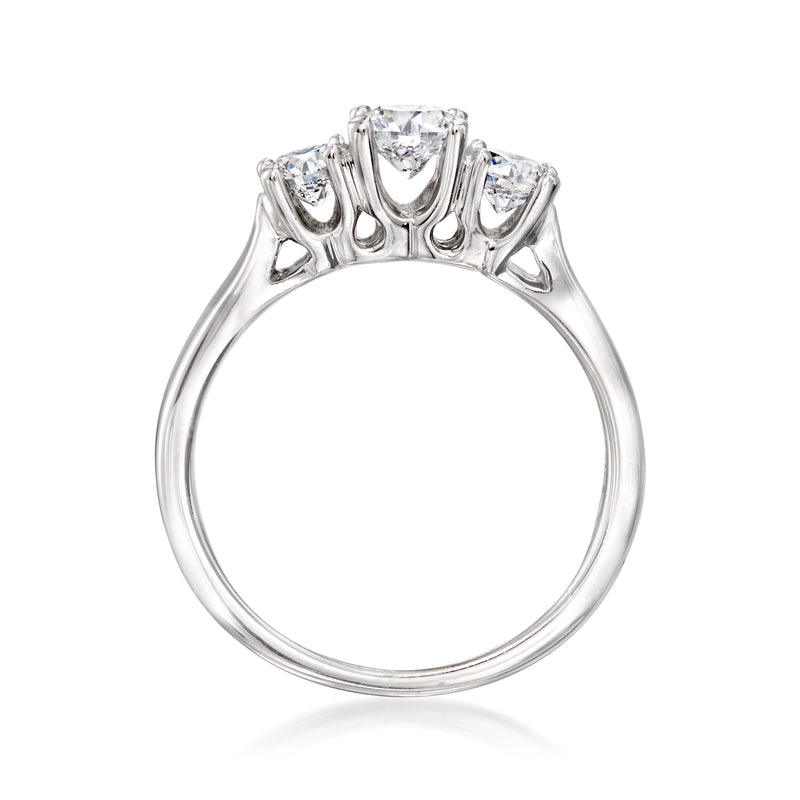 Three-stone diamond ring top view, prong-set center and two side diamonds on white gold