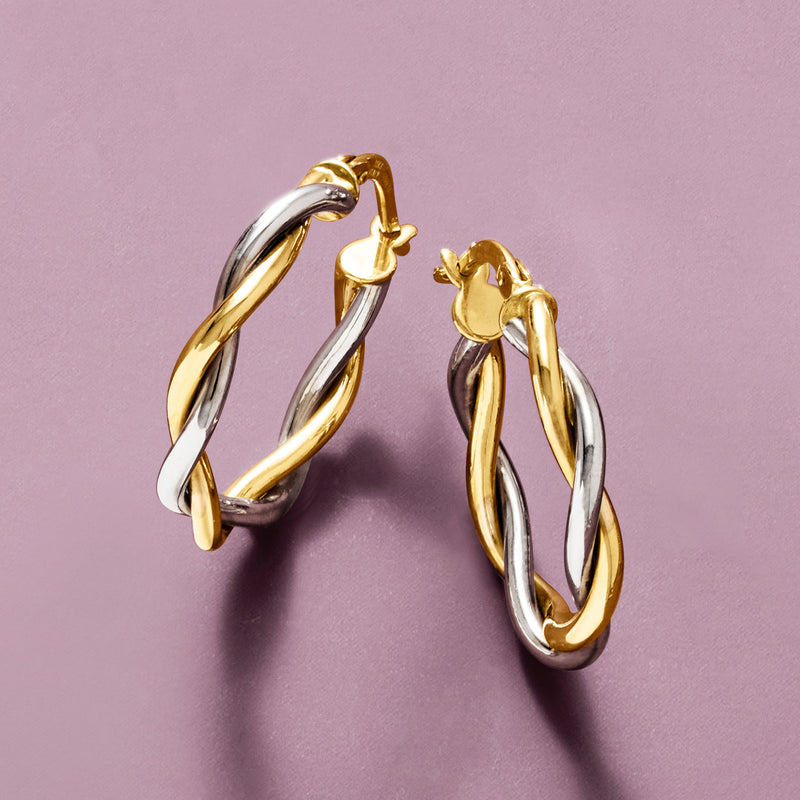 Two-tone twisted hoop earrings, gold and silver, angled pair