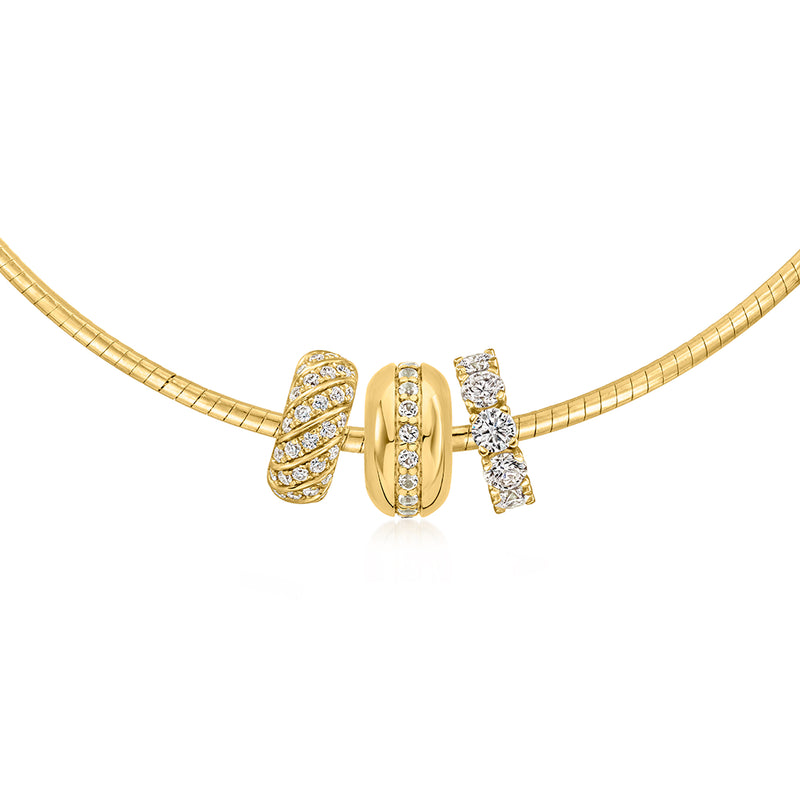 White topaz striped bead charm with three rows of round clear stones on gold necklace