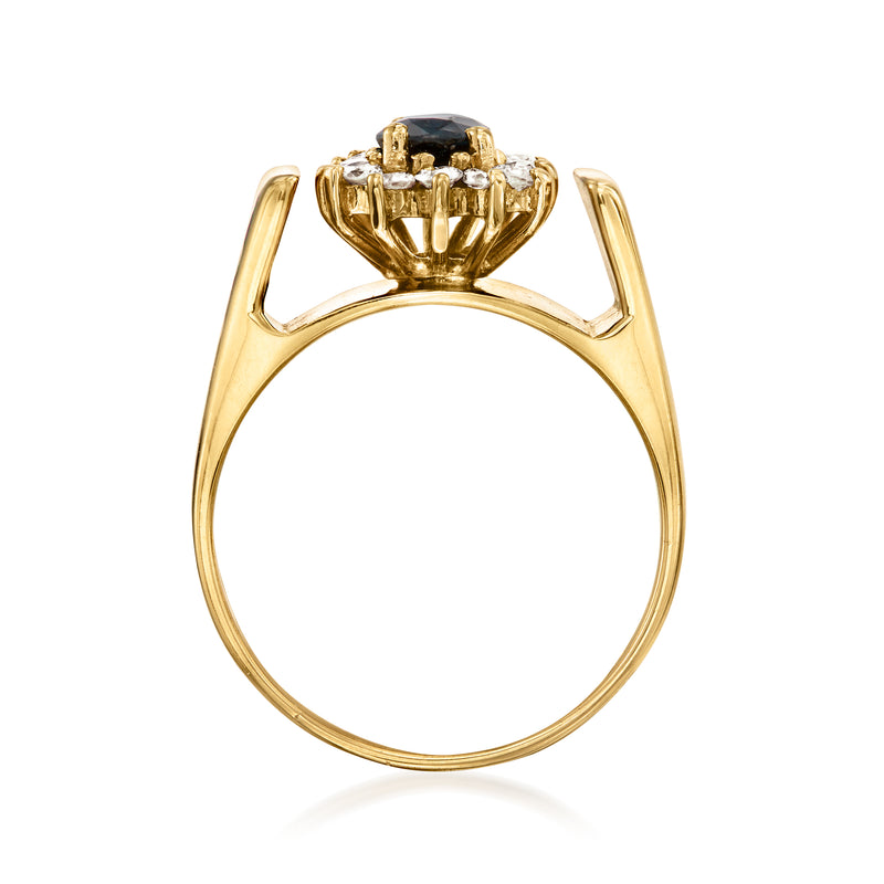 14kt yellow gold ring viewed from side, oval dark blue sapphire in diamond halo