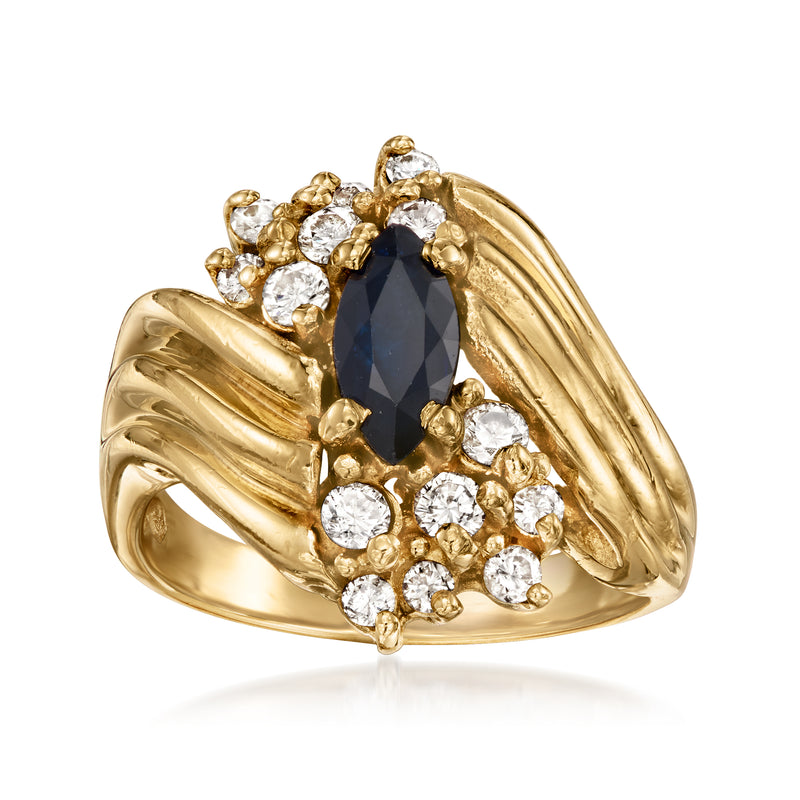 14kt yellow gold swirl ring with oval dark blue sapphire and diamond cluster accents