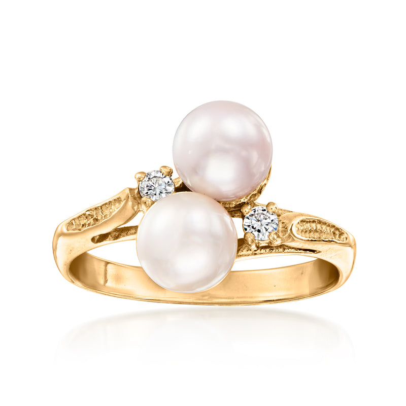 Vintage yellow gold bypass ring with two cultured white pearls and diamond accents.
