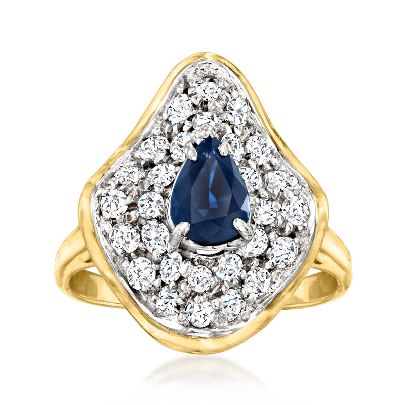 14kt yellow gold vintage ring with oval dark blue sapphire center and diamond halo