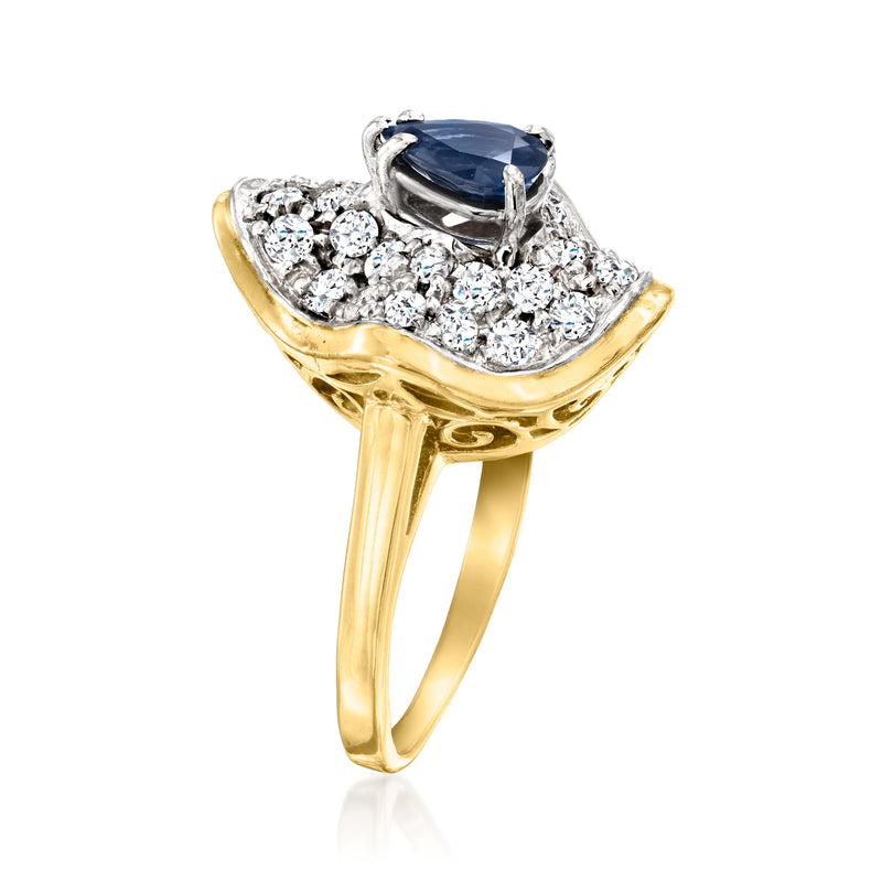 14kt yellow gold ring with dark blue sapphire and surrounding round diamonds