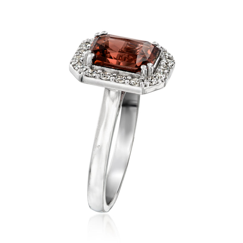 White gold ring with square orange-red gemstone and diamond halo