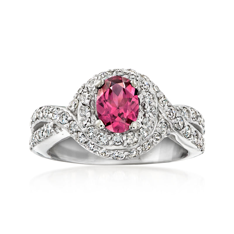 White gold ring with oval pink rhodolite center, diamond halo and pave