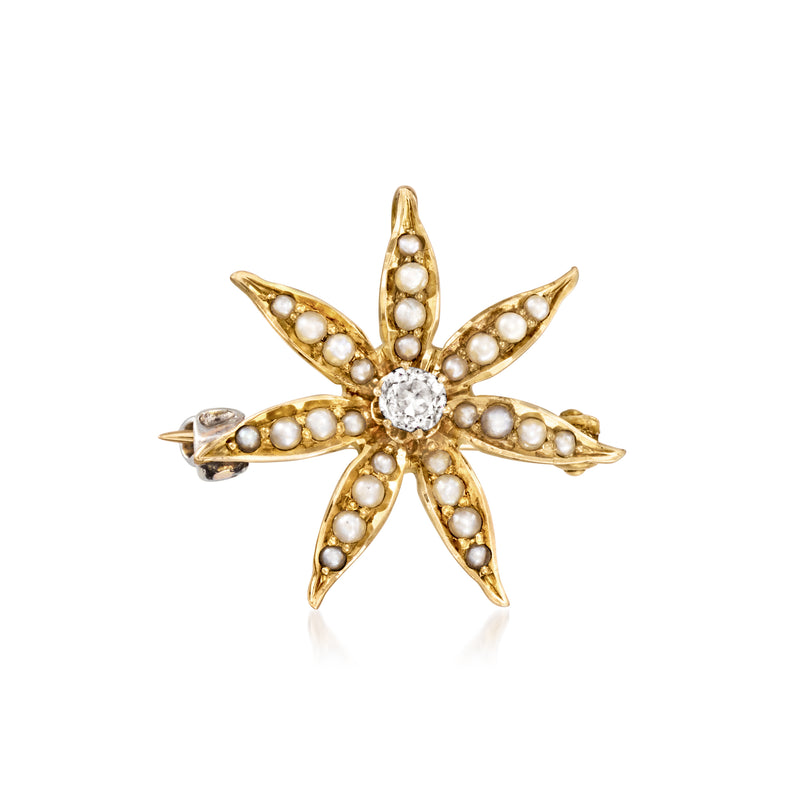 Gold flower pin with central diamond, surrounded by seed pearls and petal detail