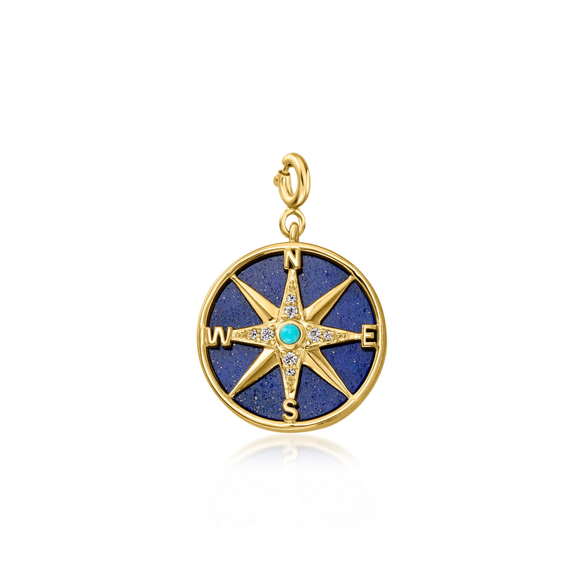 Gold compass charm with blue star dial and compass points N E S W