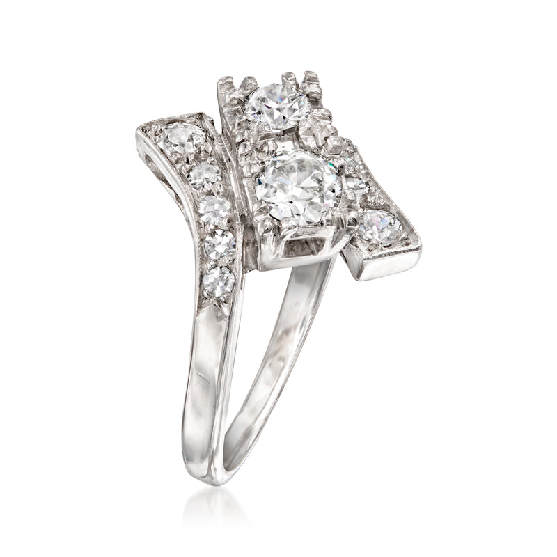 Vintage platinum bypass ring with round diamond center and pavé side stones