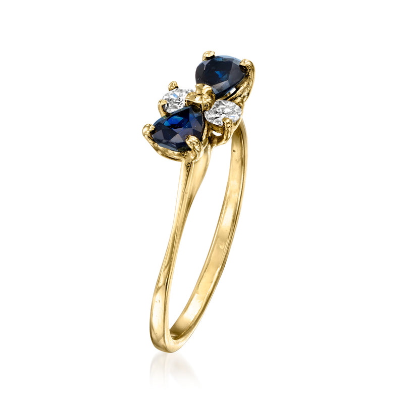 18kt yellow gold ring with dark blue marquise sapphire and round diamond stones