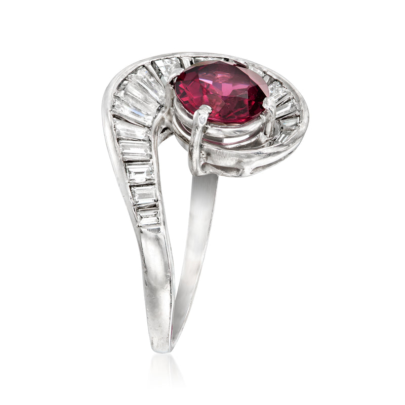 Platinum ring with oval pink rhodolite garnet center and baguette diamond frame