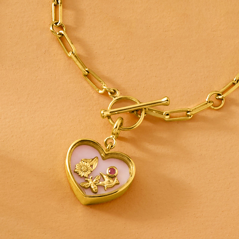Gold heart charm with pink opal enamel, floral motif and rhodolite stone on chain