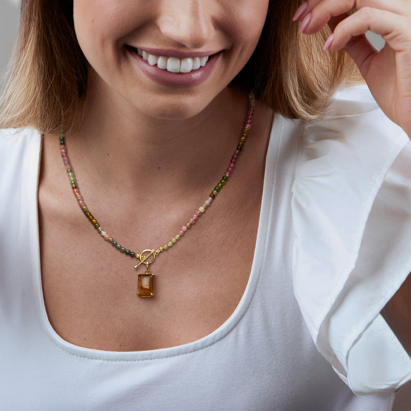 Amber square charm pendant on multicolor beaded necklace with gold-toned clasp