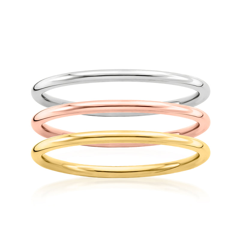 Three stackable gold rings with polished silver, rose, and yellow bands