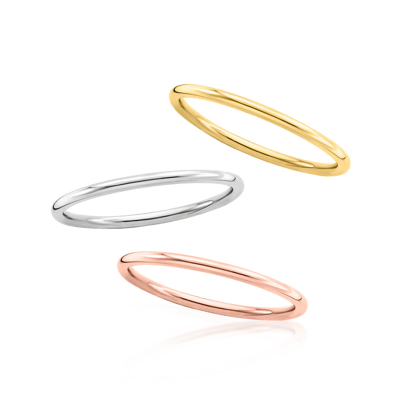 Three stackable thin gold rings: polished yellow, rose, and silver bands