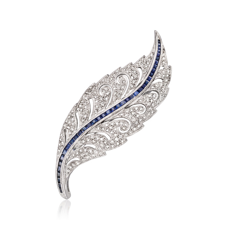 Leaf-shaped diamond and sapphire pin in 14kt white gold, curved with blue accents