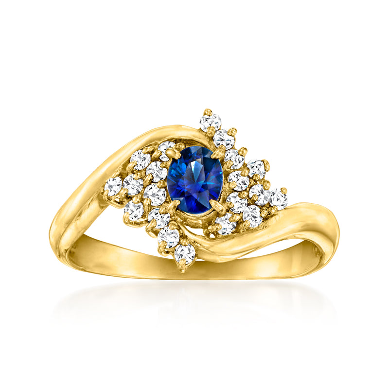 18kt yellow gold ring with oval blue sapphire center and diamond halo